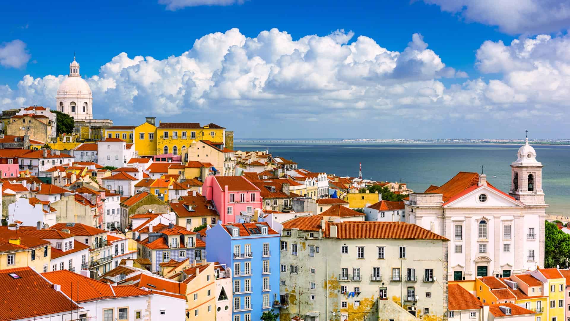 Colorful buildings and tram on a narrow street in Lisbon, Portugal